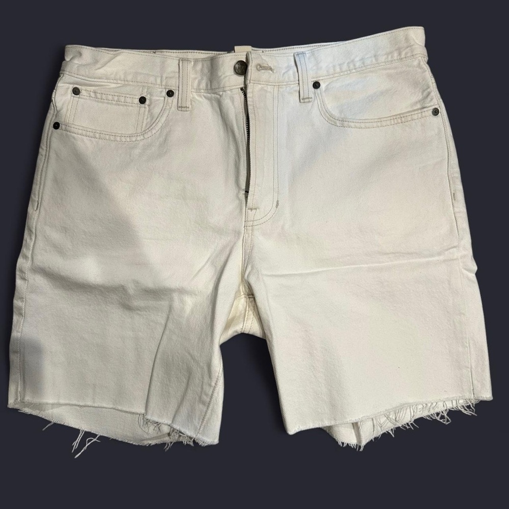 Cream denim shorts with frayed hem. 7” inseam.